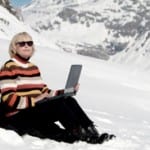 travel amrketing revolution woman using laptop in snow image