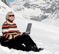 travel amrketing revolution woman using laptop in snow image